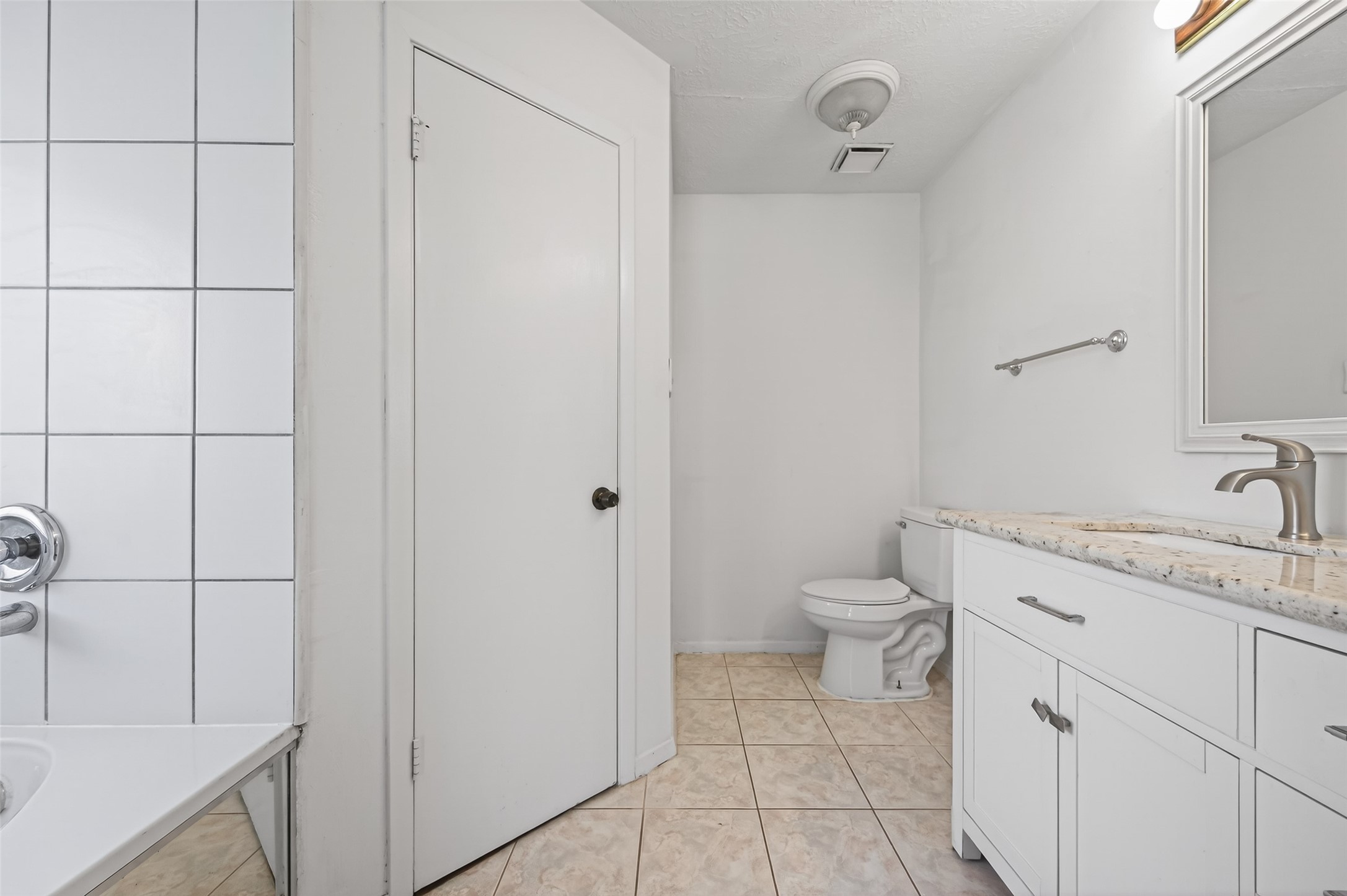 11718 Inga Lane Houston, TX 77064 - Photo 14 of 24 a spacious bathroom with a granite countertop sink toilet and a mirror