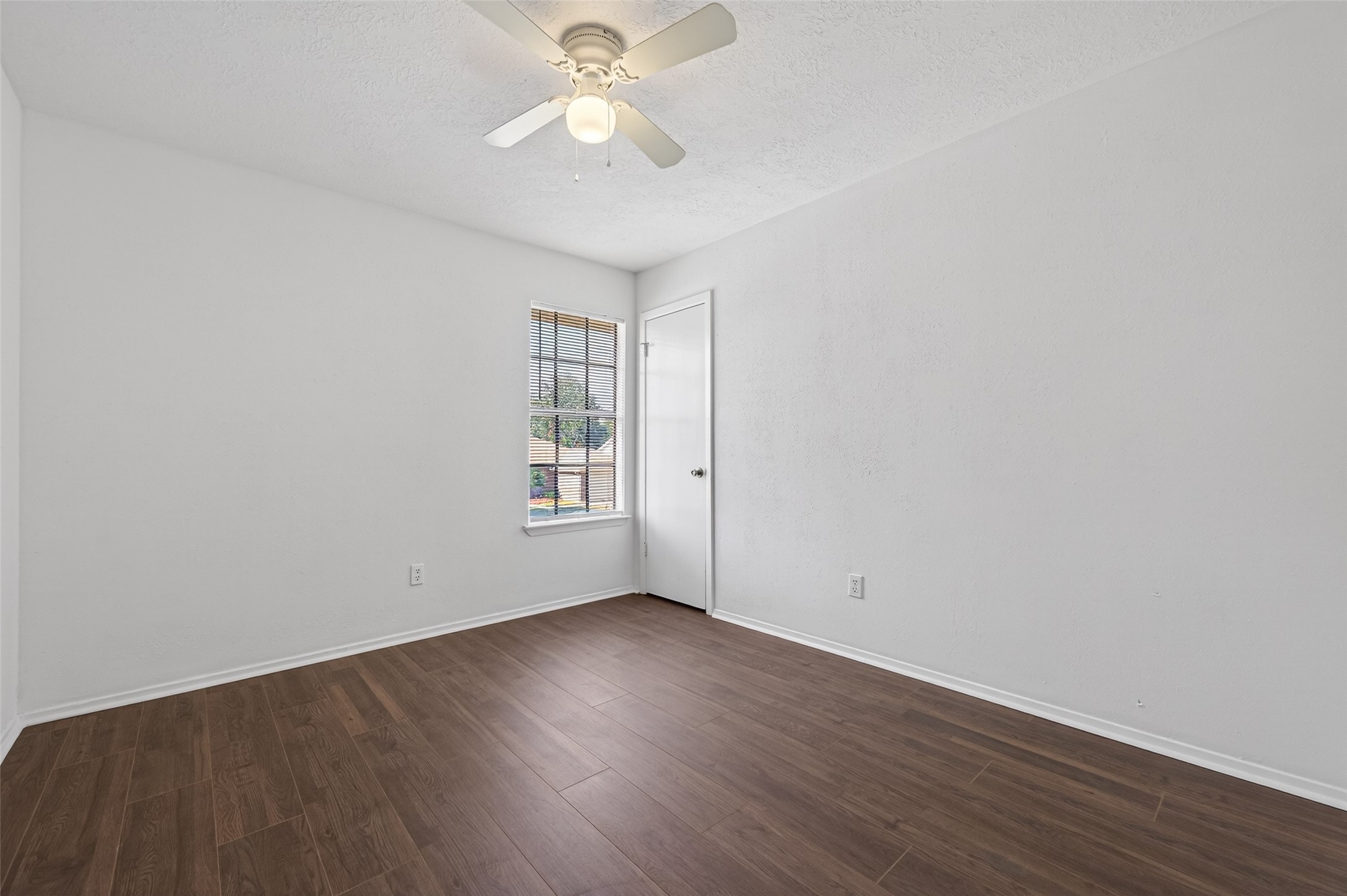 11718 Inga Lane Houston, TX 77064 - Photo 17 of 24 an empty room with wooden floor and windows