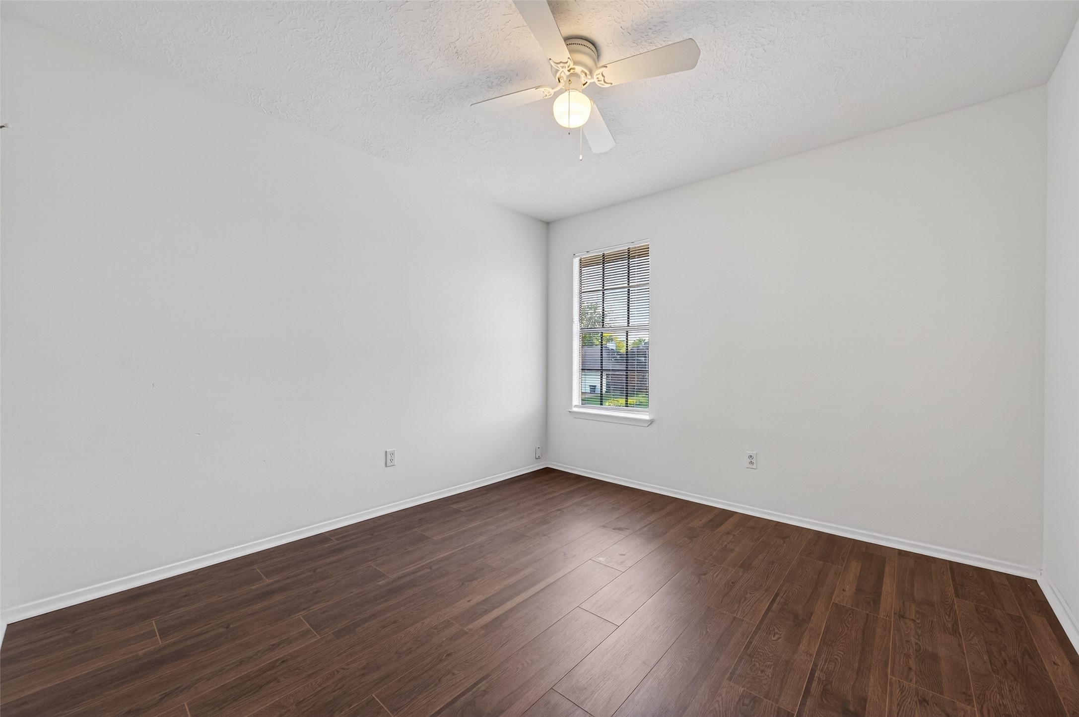 11718 Inga Lane Houston, TX 77064 - Photo 18 of 24 an empty room with wooden floor fan and windows
