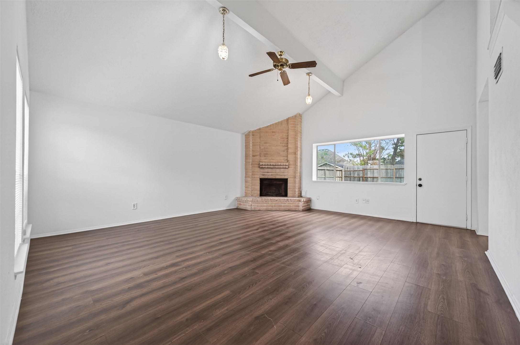 11718 Inga Lane Houston, TX 77064 - Photo 4 of 24 wooden floor in an empty room with a fireplace