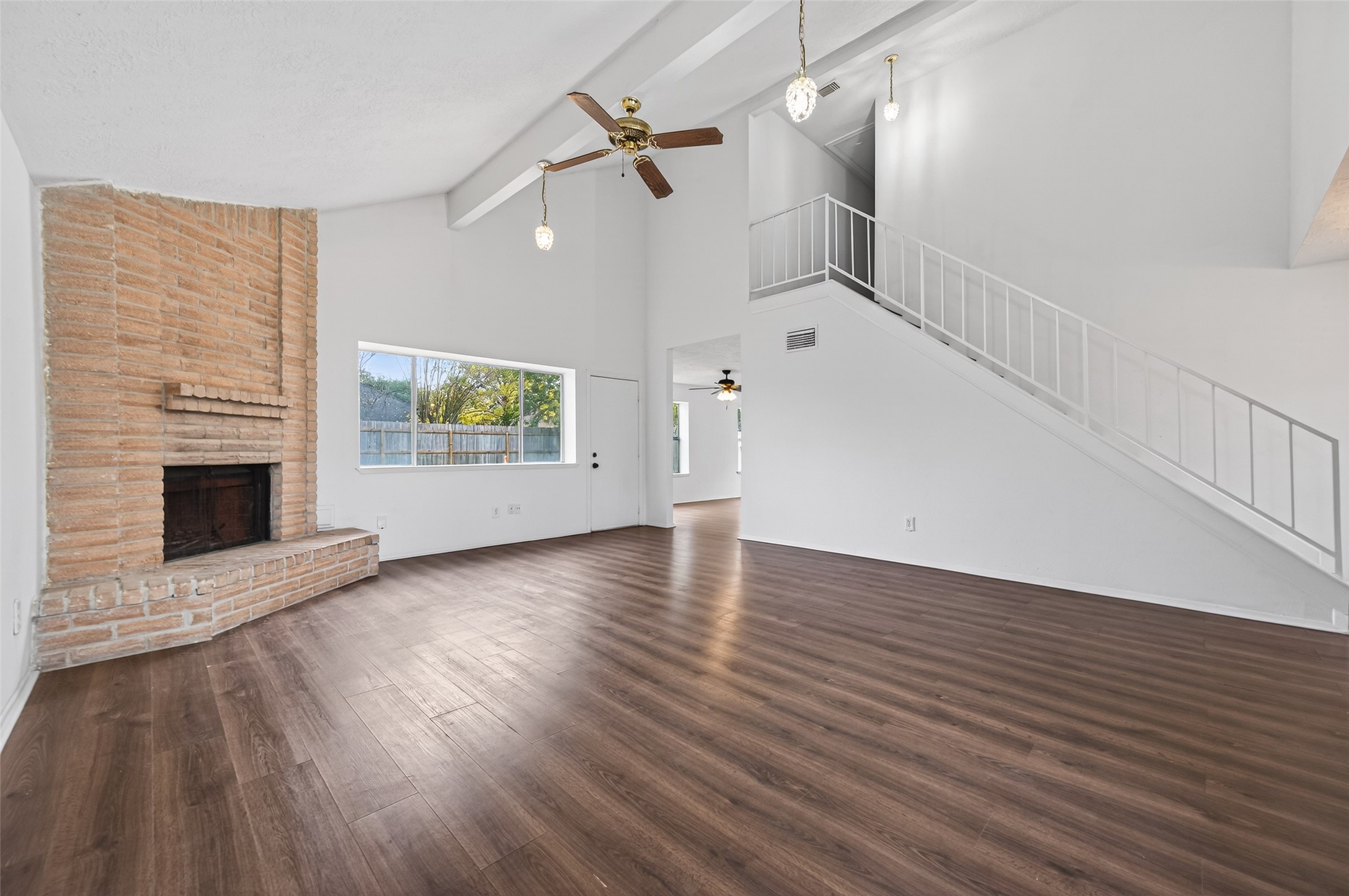 11718 Inga Lane Houston, TX 77064 - Photo 5 of 24 wooden floor in an empty room with a fireplace