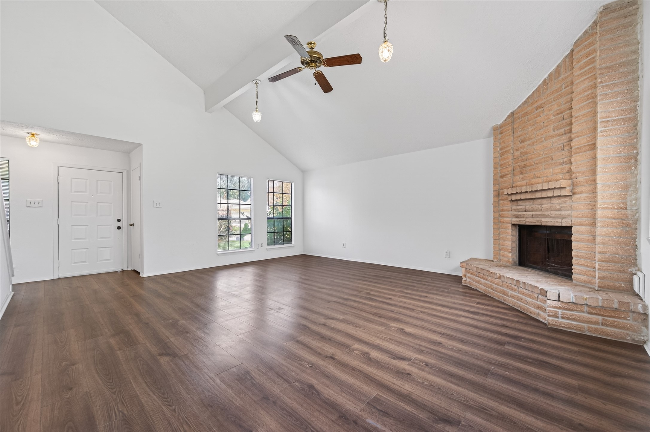 11718 Inga Lane Houston, TX 77064 - Photo 6 of 24 an empty room with wooden floor fireplace and windows