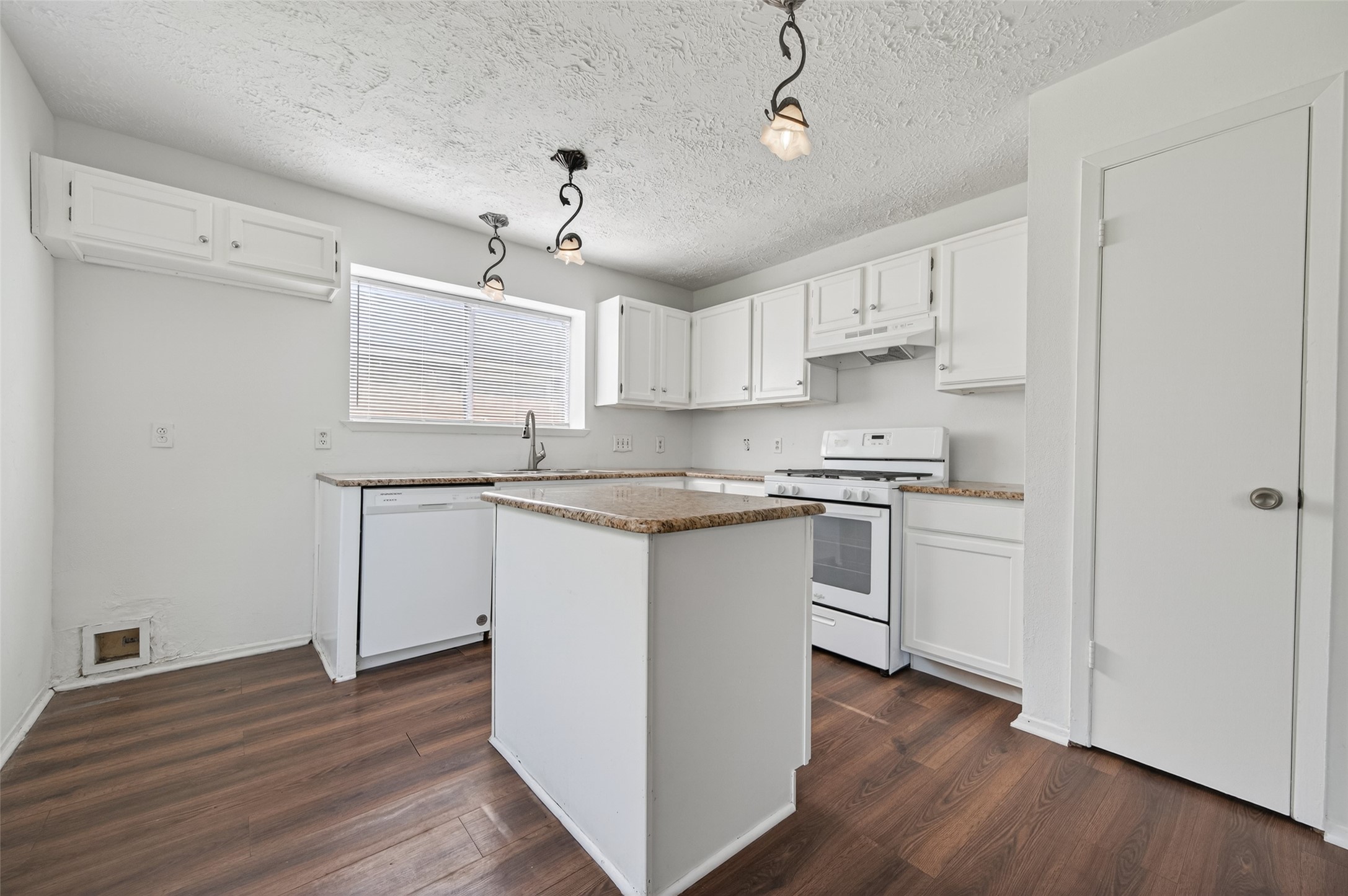 11718 Inga Lane Houston, TX 77064 - Photo 8 of 24 a kitchen with stainless steel appliances granite countertop a white stove top oven and a refrigerator with wooden floors