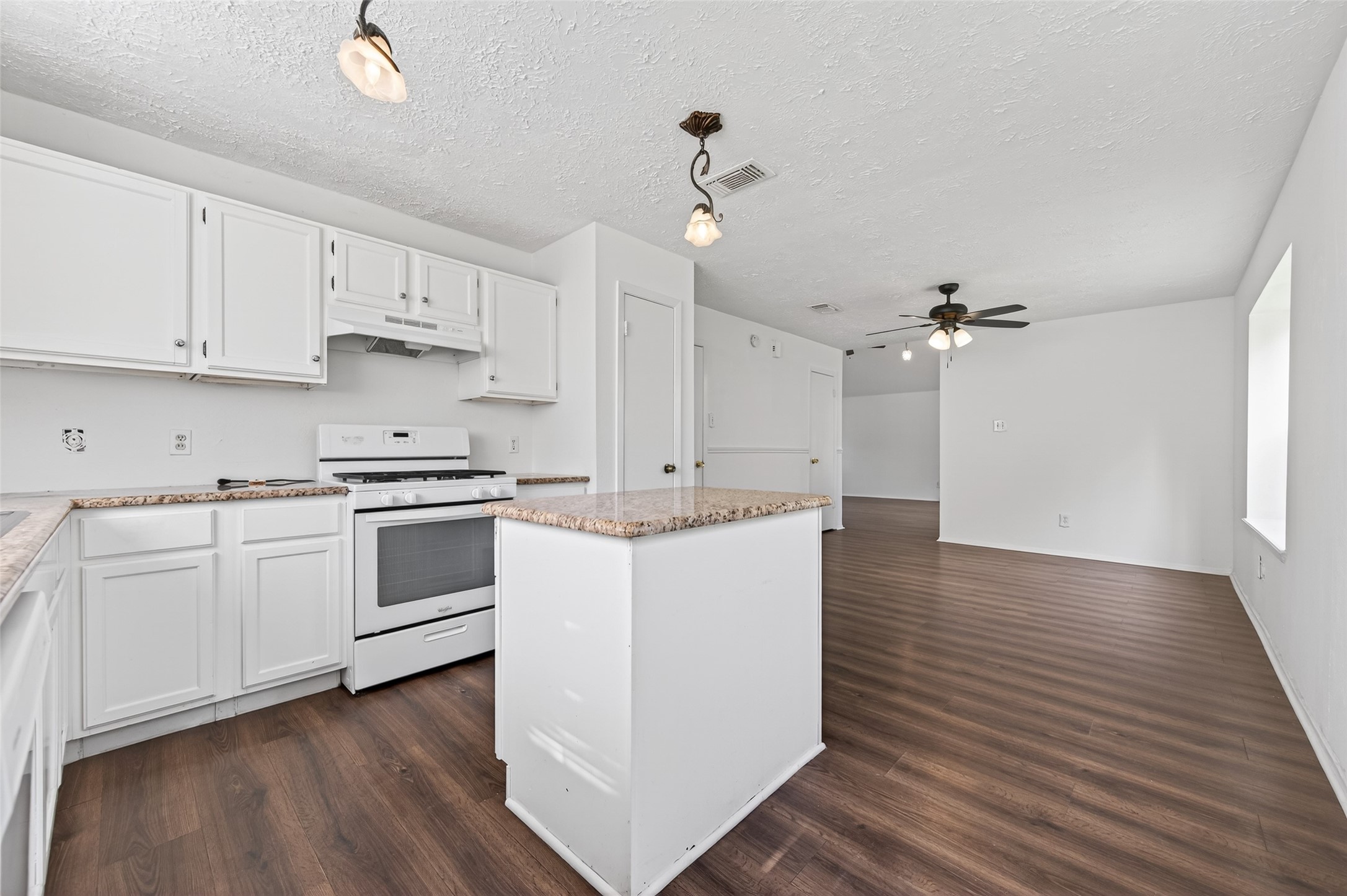 11718 Inga Lane Houston, TX 77064 - Photo 9 of 24 a kitchen with granite countertop white cabinets and white appliances