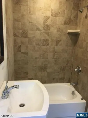 a bathroom with a tub and shower