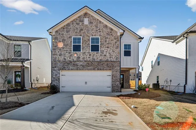 a front view of a house with garage