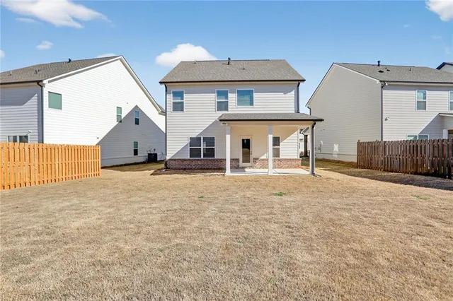 a view of a house with wooden fence