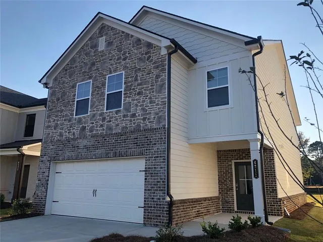 a front view of a house with garage