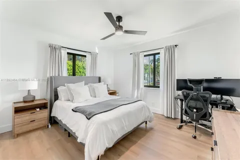 a bedroom with a bed and a desk