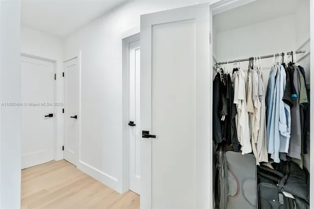 a view of walk in closet with clothes