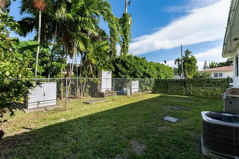 a garden with trees in front of it