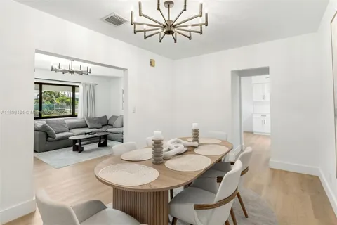 a view of a dining room with furniture and a chandelier