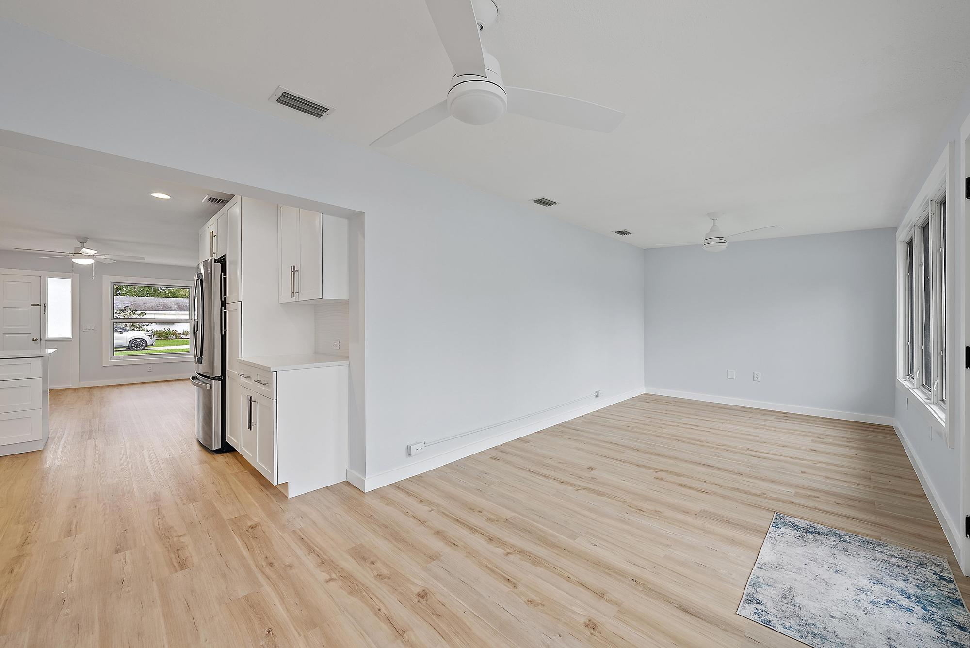 200 Anglers Circle Jupiter, FL 33458 - Photo 13 of 19 a view of an empty room with a window and wooden floor