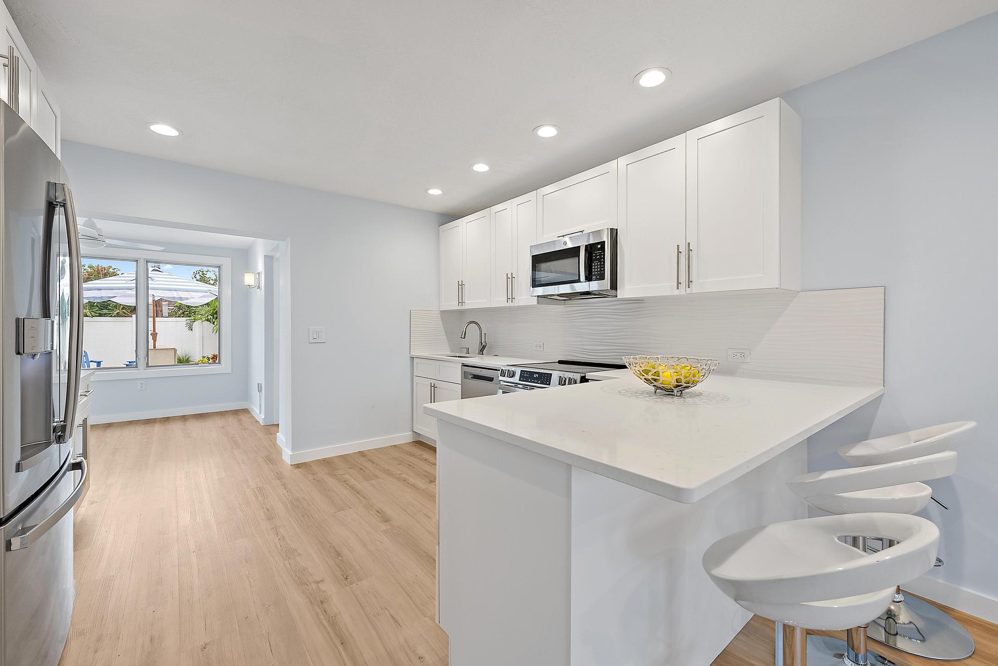 200 Anglers Circle Jupiter, FL 33458 - Photo 3 of 19 a kitchen that has a microwave a stove and a refrigerator