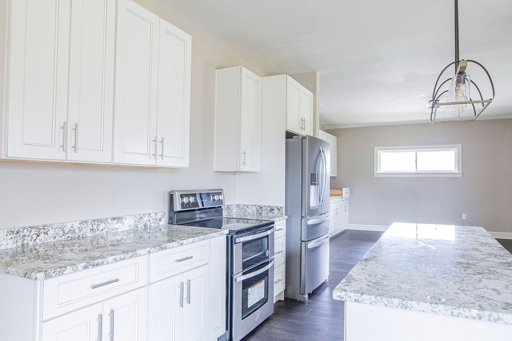 1017 Cairo Road Gallatin, TN 37066 - Photo 11 of 50 a kitchen with stainless steel appliances granite countertop a refrigerator and a stove top oven