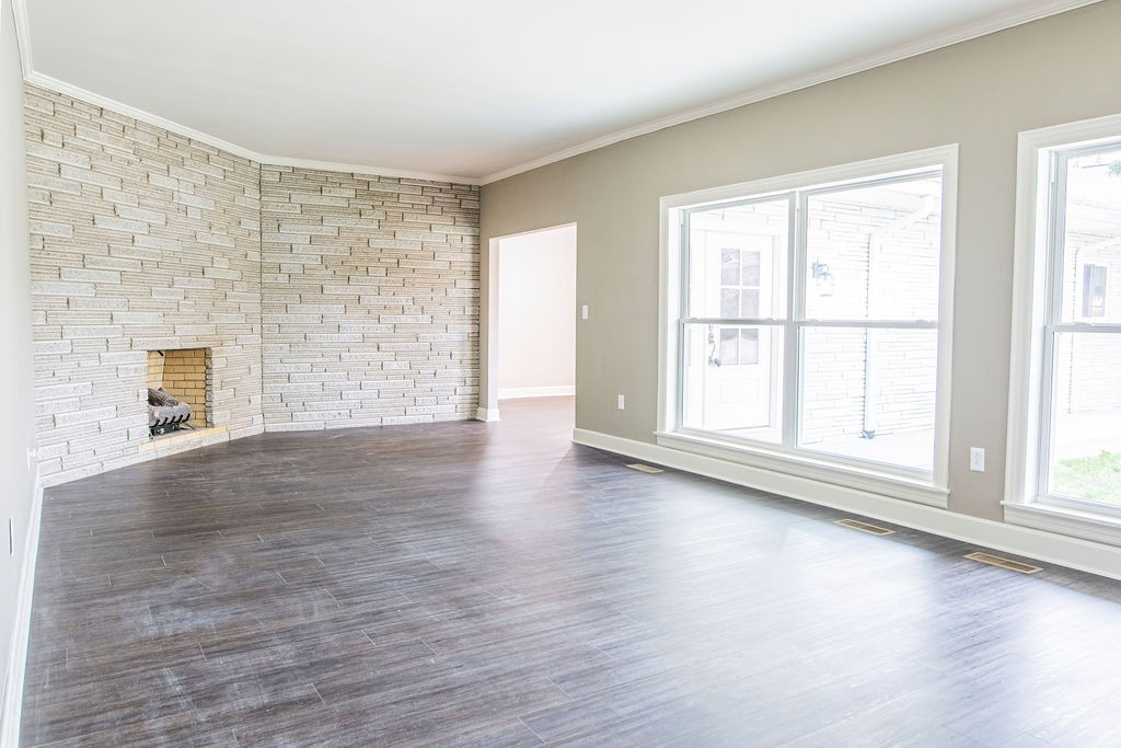 1017 Cairo Road Gallatin, TN 37066 - Photo 19 of 50 an empty room with wooden floor fireplace and windows