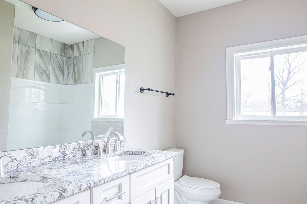 1017 Cairo Road Gallatin, TN 37066 - Photo 27 of 50 a bathroom with a granite countertop sink a toilet and a window