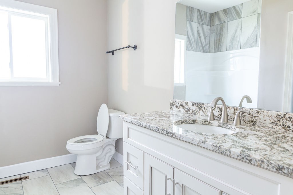 1017 Cairo Road Gallatin, TN 37066 - Photo 29 of 50 a bathroom with a granite countertop sink a toilet and a mirror
