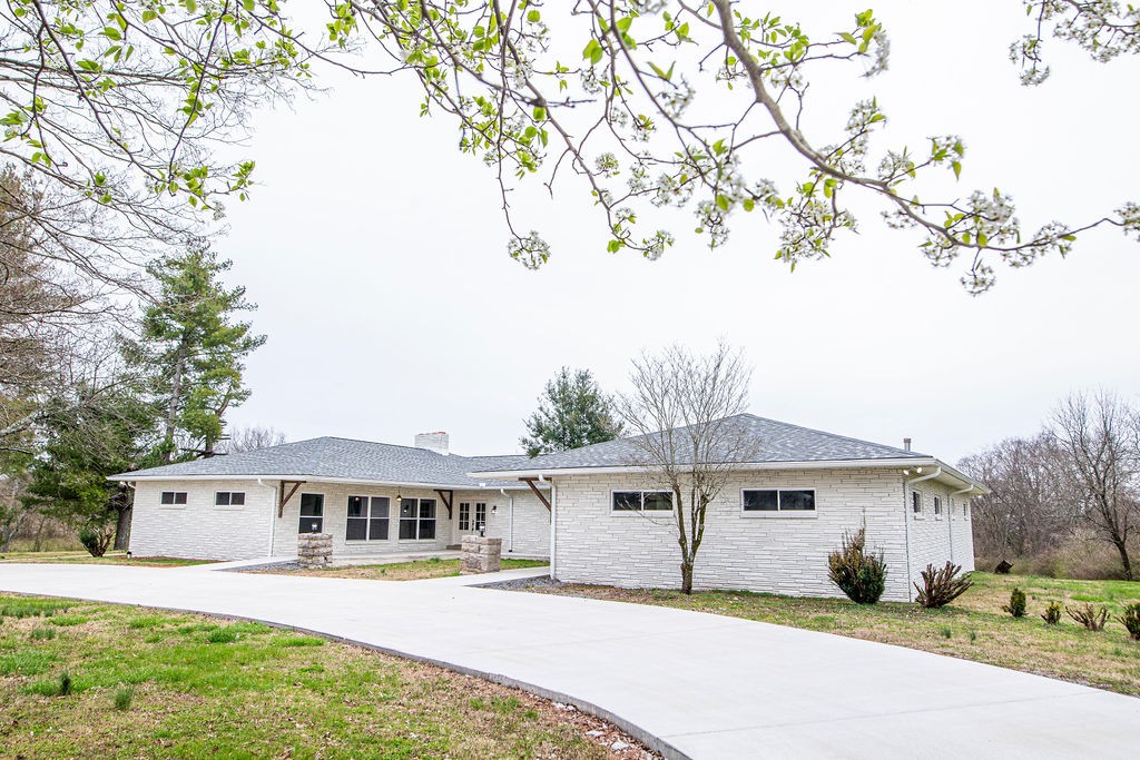 1017 Cairo Road Gallatin, TN 37066 - Photo 42 of 50 a front view of a house with a yard and trees