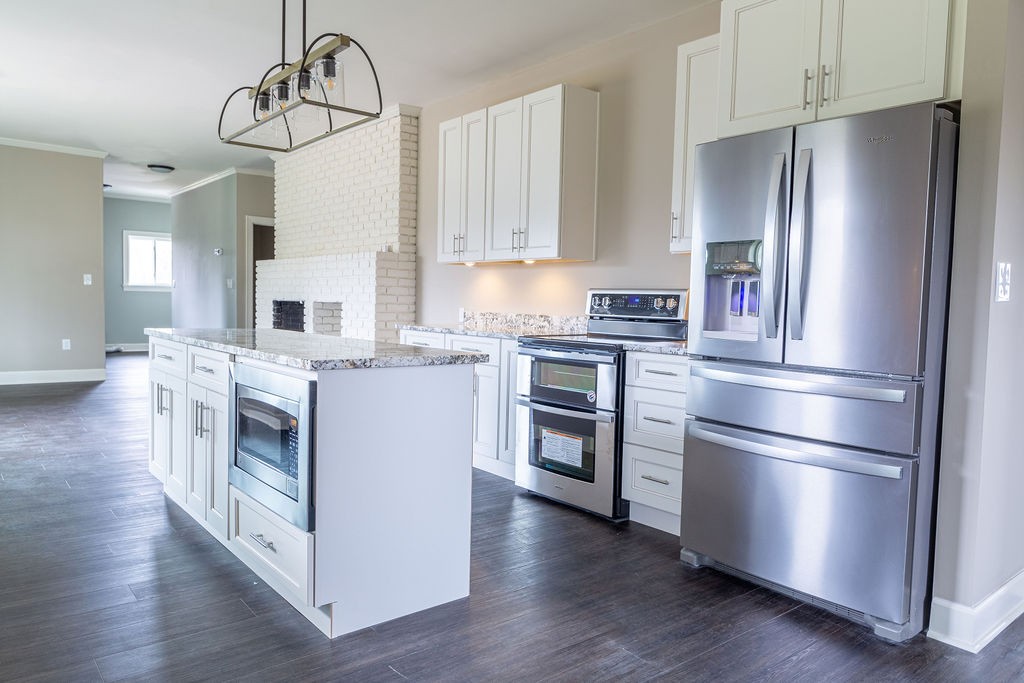 1017 Cairo Road Gallatin, TN 37066 - Photo 7 of 50 a kitchen with stainless steel appliances a refrigerator stove and wooden floor