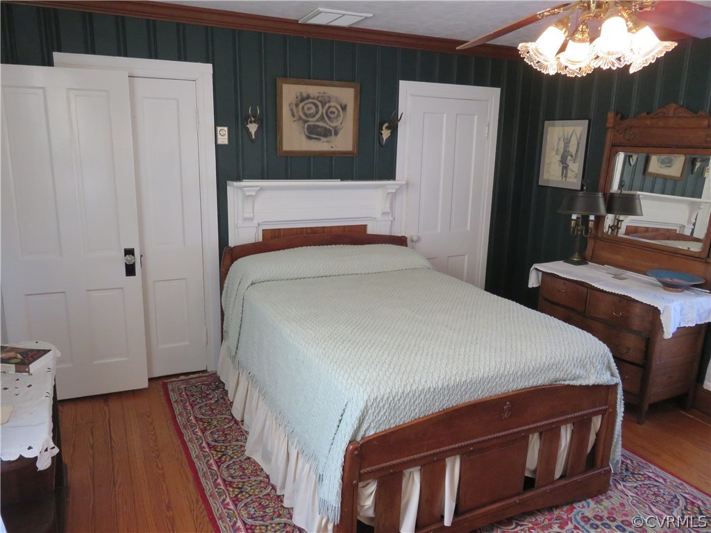5900 Sharps Road Warsaw, VA 22572 - Photo 50 of 50 a bedroom with a bed next to a window with wooden floor