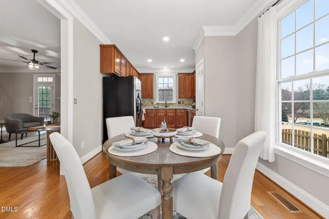 a dining room with furniture a window and wooden floor