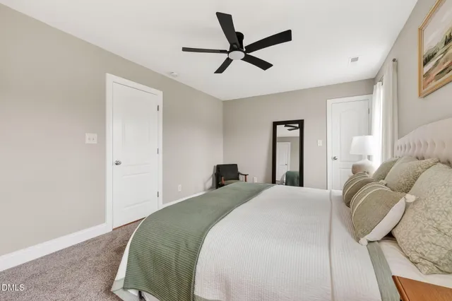 a bedroom with a bed and ceiling fan