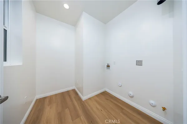 a view of room with wooden floor