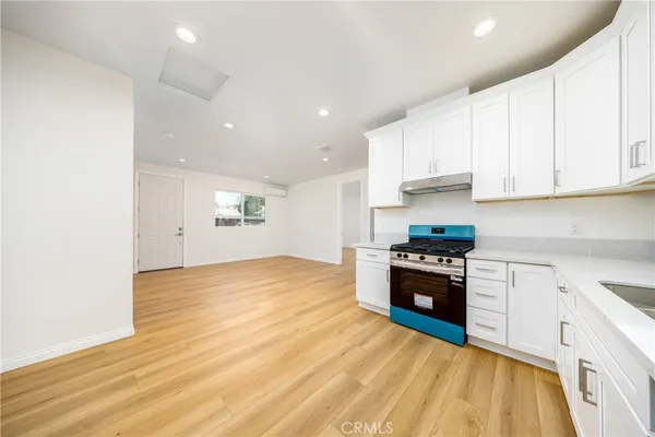 a kitchen with granite countertop a stove and a sink