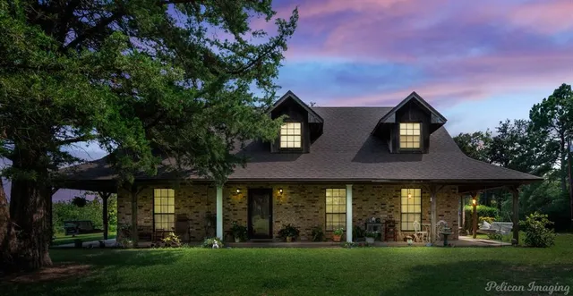 a front view of a house with a garden and plants