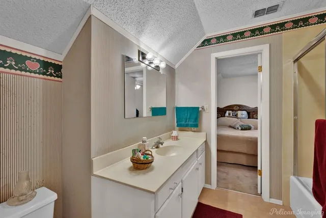 a bathroom with a sink toilet and mirror