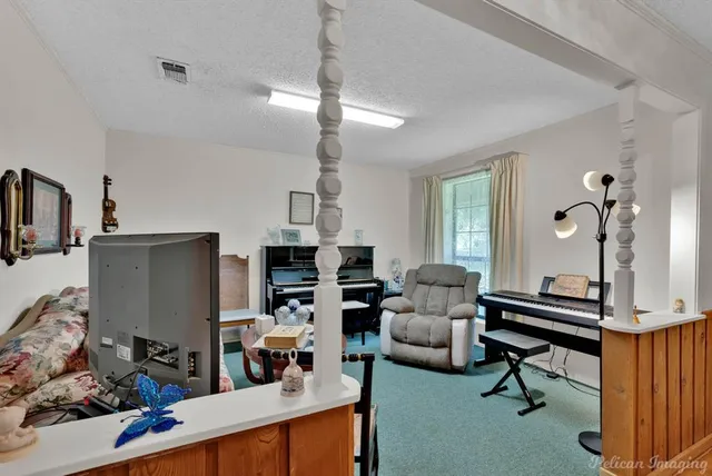 a living room with furniture a rug and a chandelier
