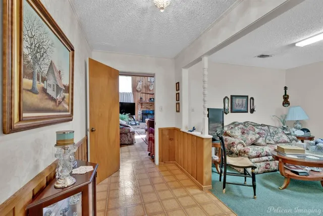 a living room with furniture and a painting on the wall