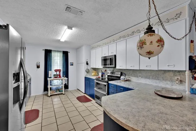 a kitchen with sink cabinets and stainless steel appliances