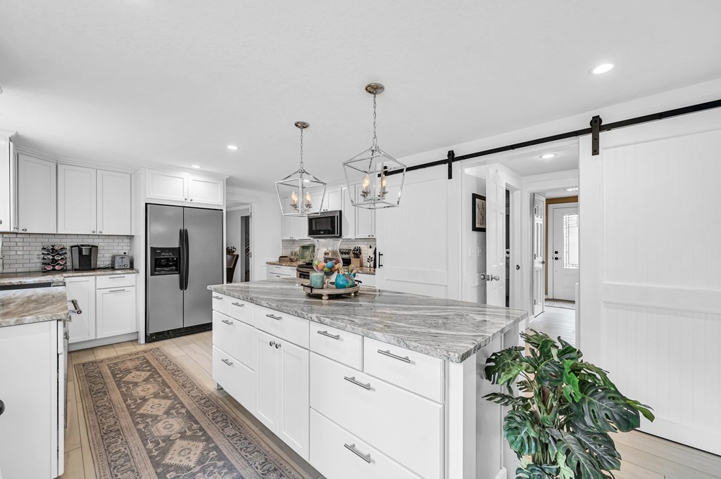 45 Scantic Road Hampden, MA 01036 - Photo 11 of 37 a kitchen with white cabinets and stainless steel appliances