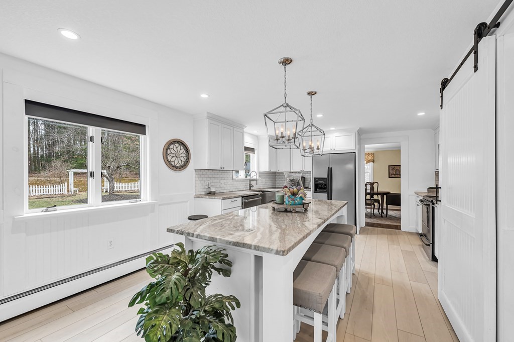 45 Scantic Road Hampden, MA 01036 - Photo 10 of 37 a large kitchen with stainless steel appliances granite countertop a lot of counter space and a chandelier