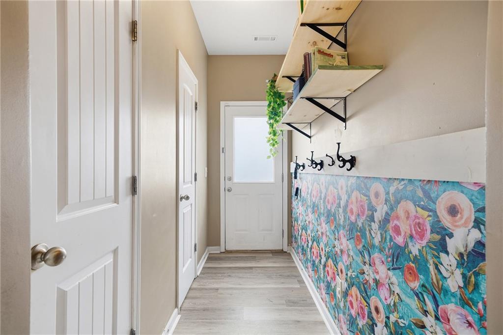 615 Myers Gate Road Ball Ground, GA 30107 - Photo 20 of 43 a view of a hallway with wooden floor and front door
