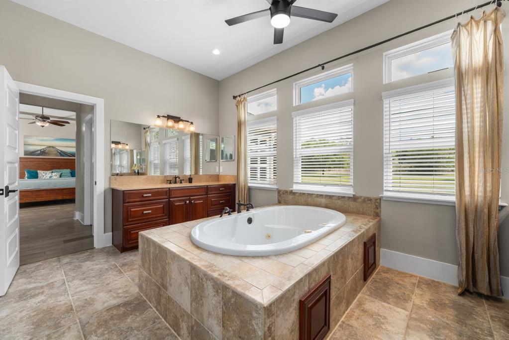 1751 Southwest 188th Street Newberry, FL 32669 - Photo 17 of 93 a bathroom with a sink double vanity and a tub