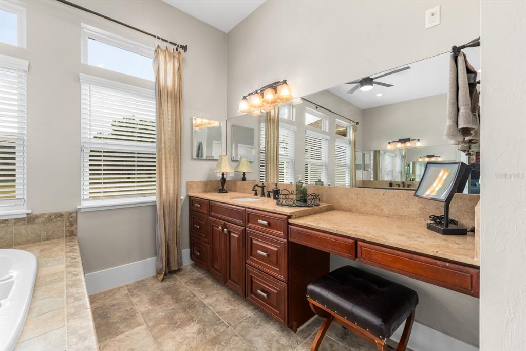 1751 Southwest 188th Street Newberry, FL 32669 - Photo 18 of 93 a spacious bathroom with a granite countertop sink and a mirror