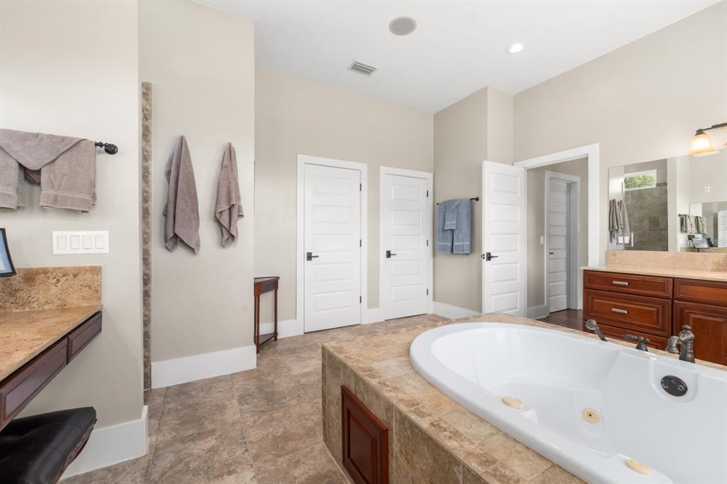 1751 Southwest 188th Street Newberry, FL 32669 - Photo 20 of 93 a bathroom with a tub sink and mirror