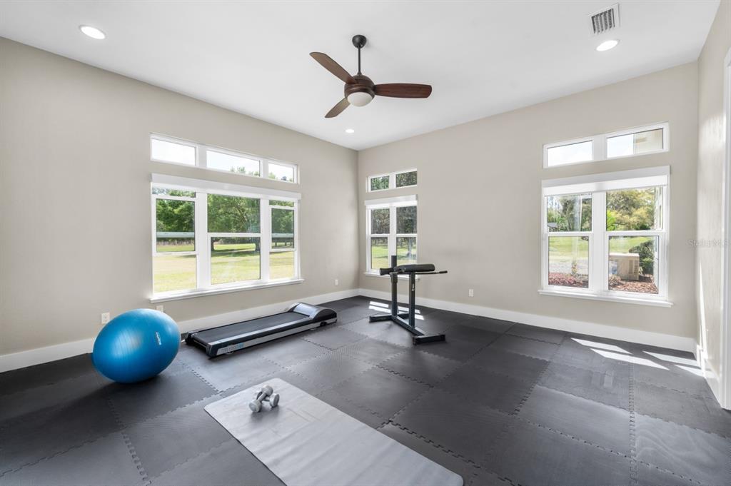 1751 Southwest 188th Street Newberry, FL 32669 - Photo 24 of 93 a view of a room with gym equipment and windows