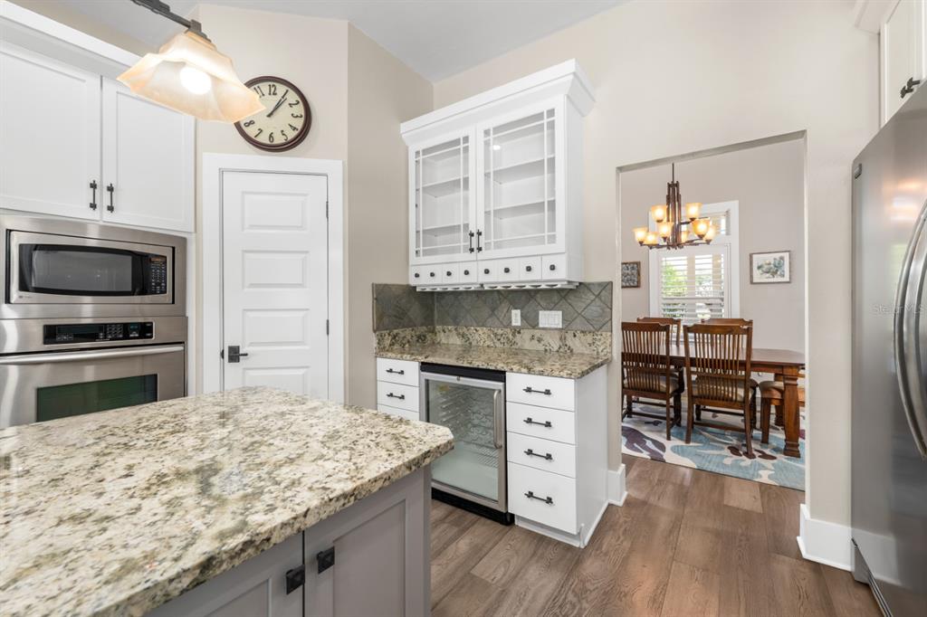 1751 Southwest 188th Street Newberry, FL 32669 - Photo 35 of 93 a kitchen with stainless steel appliances kitchen island granite countertop a stove refrigerator and cabinets