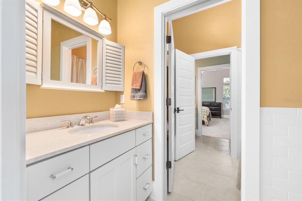1751 Southwest 188th Street Newberry, FL 32669 - Photo 43 of 93 a en suite bathroom with a sink and mirror with bathtub