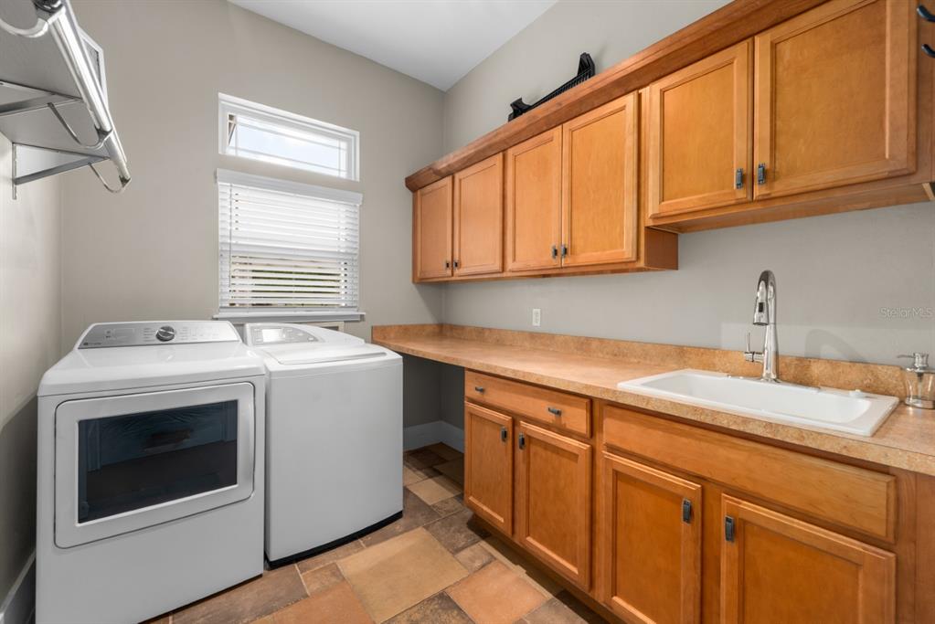 1751 Southwest 188th Street Newberry, FL 32669 - Photo 51 of 93 a utility room with sink dryer and washer