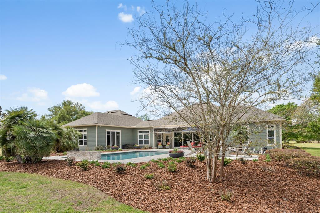1751 Southwest 188th Street Newberry, FL 32669 - Photo 63 of 93 a front view of a house with a garden