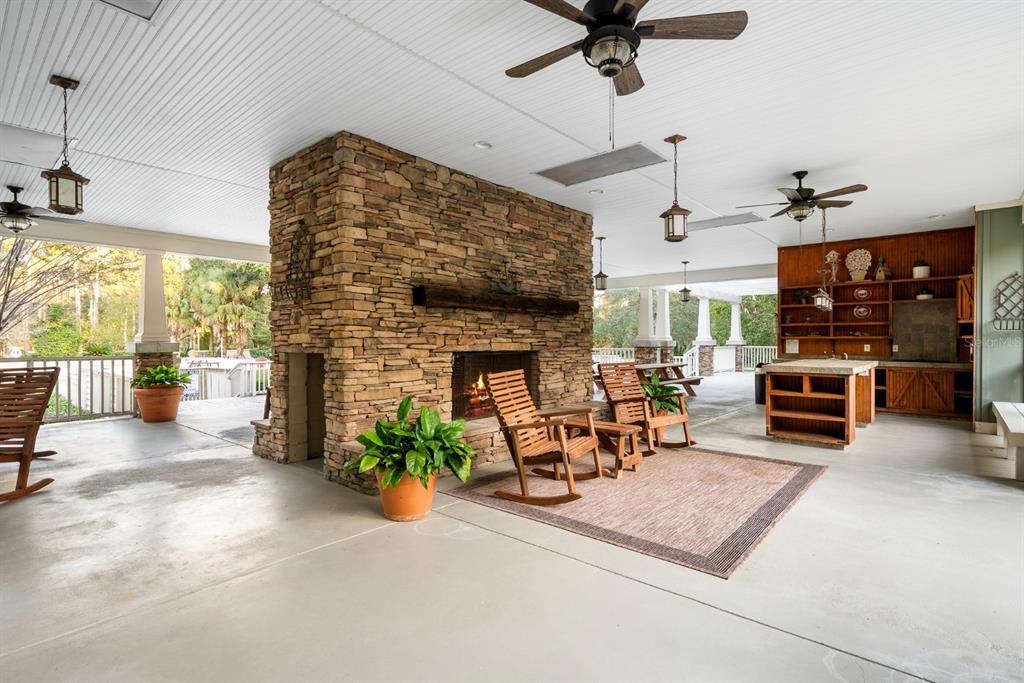 1751 Southwest 188th Street Newberry, FL 32669 - Photo 86 of 93 a living room with furniture a fireplace and a chandelier
