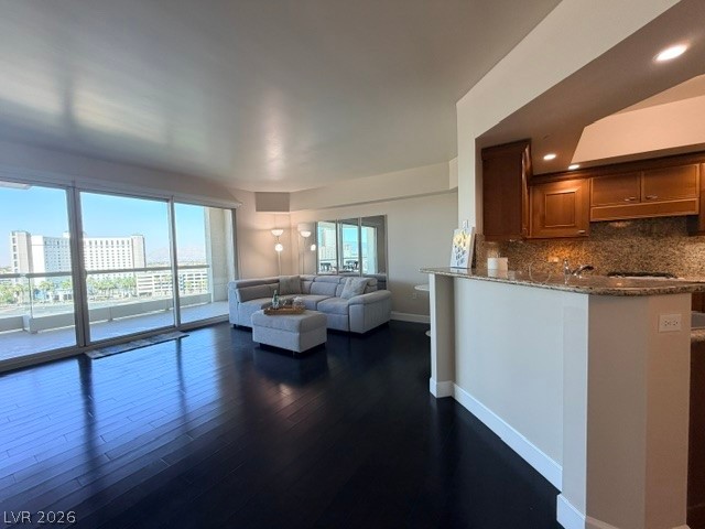 2777 Paradise Road, Unit 807 Las Vegas, NV 89109 - Photo 38 of 61 City views and a private balcony elevate this spacious living area with hardwood floors and a well-appointed kitchen.