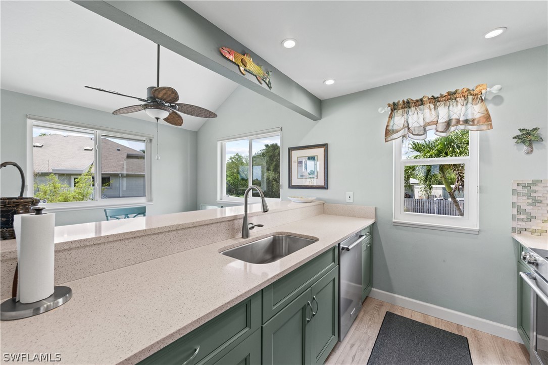 1649 Sand Castle Road Sanibel, FL 33957 - Photo 11 of 34 a kitchen with a sink and a refrigerator