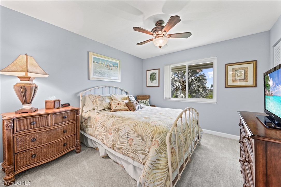 1649 Sand Castle Road Sanibel, FL 33957 - Photo 19 of 34 a bedroom with a bed and a chandelier