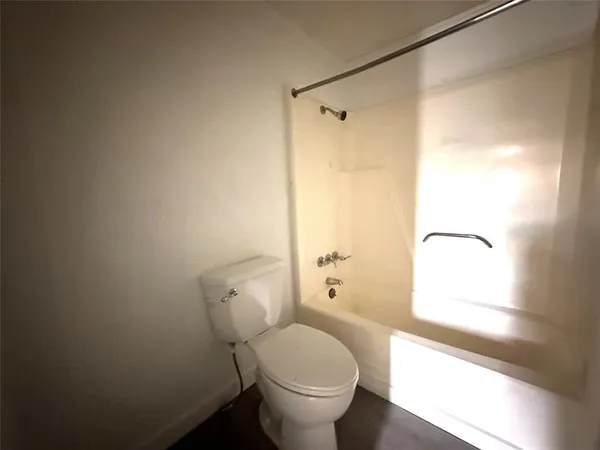a bathroom with a granite countertop toilet sink and shower